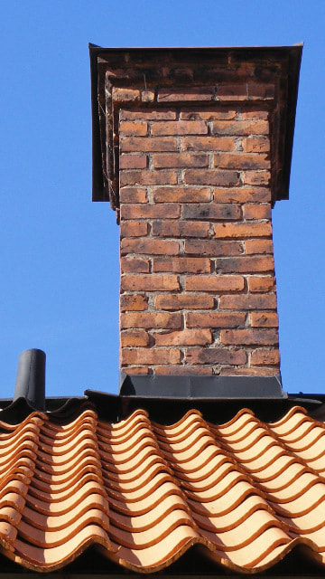 brick chimney with black flashing