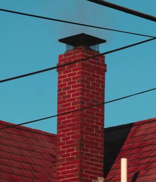 red brick chimney with rain cap