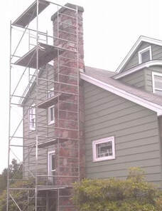 scaffolding next to house with chimney repair in progress